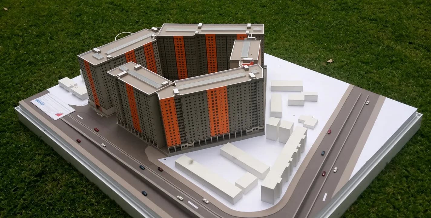 Model maker hands crafting an architectural scale model